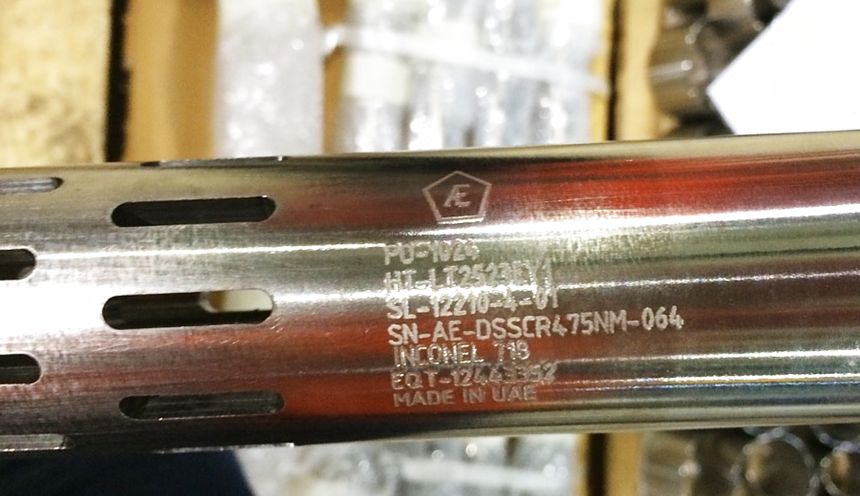 Close view of serialized marking on a metallic AE Downhole Filter Sub part